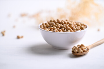 Soybean seeds in bowl with spoon, food ingredients high protein good for vegetarian and vegan