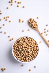 Soybean seeds in bowl with spoon, food ingredients high protein good for vegetarian and vegan