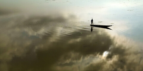 aerial view of a fisherman in his boat on the mekong river	