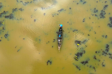 aerial view of a fisherman in his boat on the mekong river	