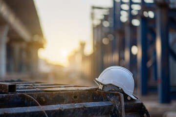The hard plastic helmet of an engineer placed on the elevated construction site around the city.
