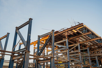 Massive steel scaffolding supports the concrete bridge structure that creates a way around the city highway.
