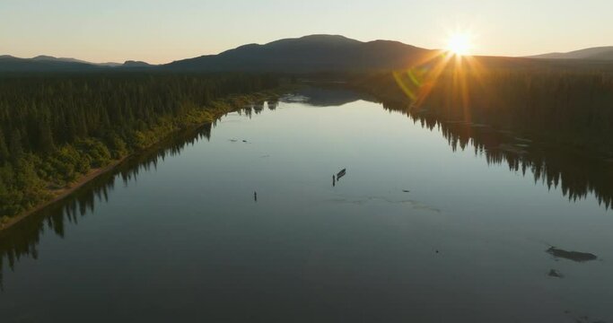Gorgeous high flying view of a fisherman fly casting out in the Flowers river in Labrador, Canada