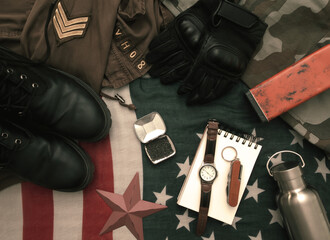 Overhead flat lay of military items laid out on an American flag