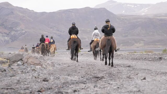 Tourist riding horses in Thórsmörk valley in Iceland, recreational activity