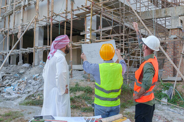 Diverse team of professionals using tablet computers on construction site. Real estate construction project. with civil engineers, architects, Arabic business investors and explorer with theodolite