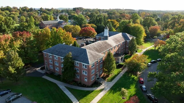 Student housing on American college campus. Dormitory dorm building. Exterior aerial view in autumn.