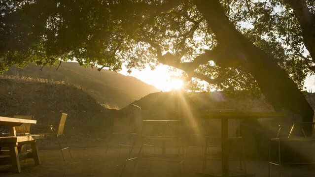 Timelapse sun sets behind wooded hillside in Ensenada, Mexico