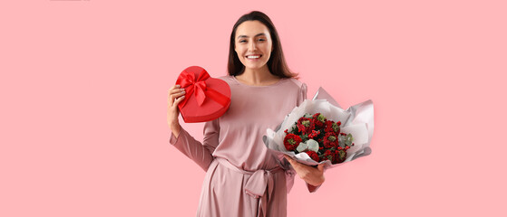 Pretty woman with gift and bouquet of flowers on pink background. Valentine's Day celebration