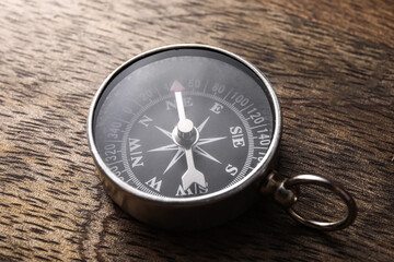 Fototapeta na wymiar Retro compass on dark wooden background, closeup
