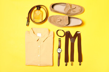 Male clothes, different accessories and shoes on yellow background