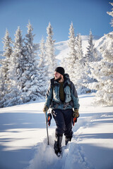 Fototapeta na wymiar Mountaineer man in winter mountains. Hiking in Carpathian mountains, Ukraine. Hoverla