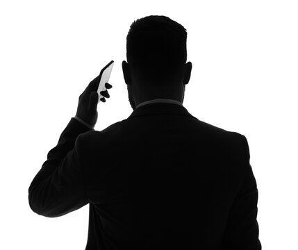 Silhouette of businessman talking by mobile phone on white background, back view