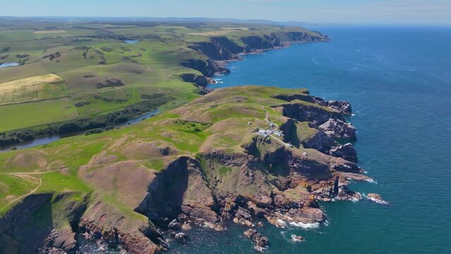 St. Abbs Lighthouse and coastal cliffs aerial view in summer near village of St. Abbs, Berwickshire, Scotland, UK. 