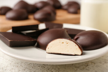Plate with sweet chocolate bird's milk candies, closeup