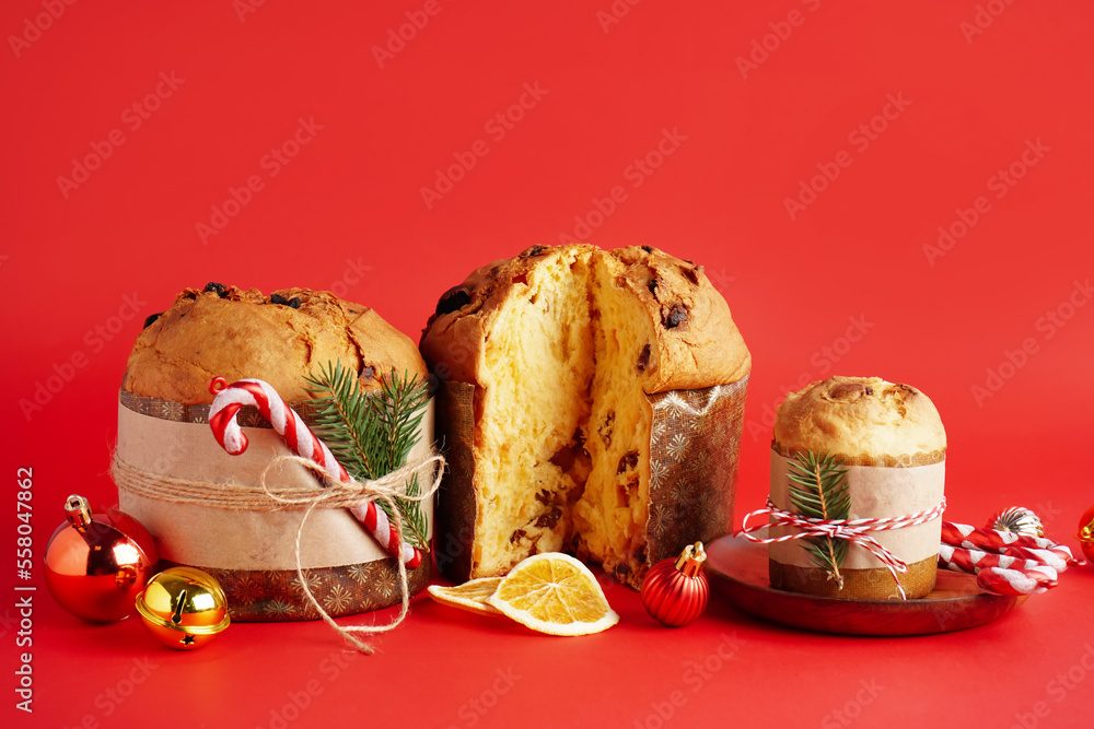 Wall mural tasty panettones with christmas decor on red background