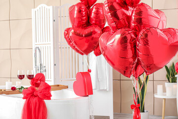Heart-shaped balloons for Valentine's Day in interior of bathroom