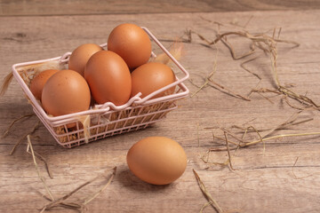 Fresh eggs in a basket on a wooden background.Copy space.