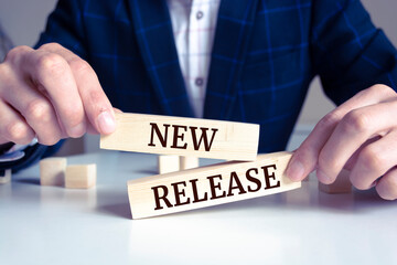 Wooden blocks with words 'NEW RELEASE'. Business concept