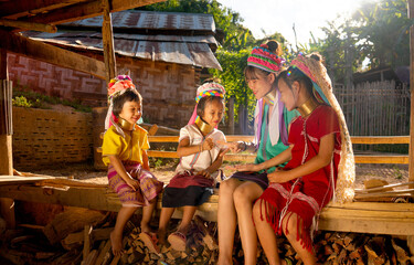 Group of Asian girls and woman of Long Neck Karen Village enjoy to play with rock-paper-scissors...