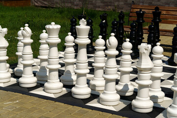 Giant garden chess set set out for a game of chess giant chess board. Selective focus