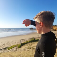 child looking at the sea
