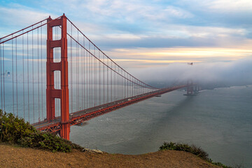 Fototapeta na wymiar Sunset view of the Golden Gate Bridge and fog from Battery Spencer. 