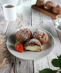 Chocolate cream puff served on a white plate