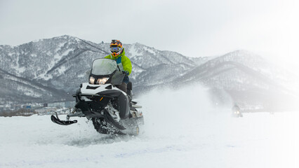 The Snowmobile in high jump above track.
