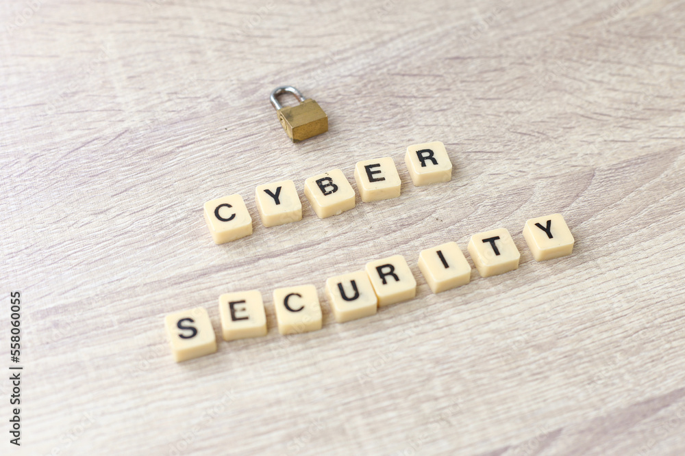 Poster lock and alphabet square tiles with the word cyber security on wooden background. cyber security con