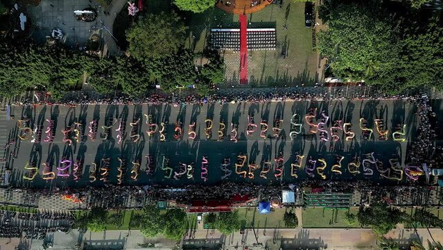 Top view of dragon dance perform celebration new year. Group of people perform a traditional lion dance and dragon dance. Guinness record performance of 54 Dragons dance on the street Vung Tau.