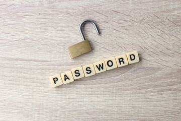 Lock and alphabet square tiles with the word password on wooden background. Cyber security concept.