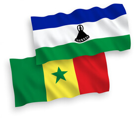 Fototapeta premium National vector fabric wave flags of Republic of Senegal and Lesotho isolated on white background. 1 to 2 proportion.