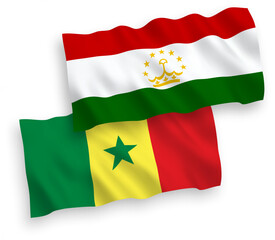 National vector fabric wave flags of Republic of Senegal and Tajikistan isolated on white background. 1 to 2 proportion.