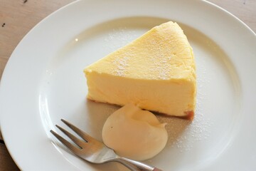 cheese cake with cream on white plate