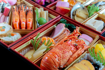 お節料理の重箱を俯瞰したクローズアップ。日本料理,季節料理,お祝いのイメージ