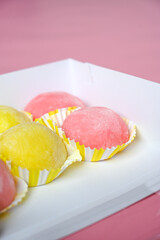 Many different delicious mochi in box, closeup. Traditional Japanese dessert side view