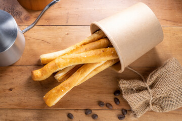 Butter breadstick or long pastry in paper bucker.