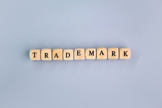 wooden letters with the word trademark. own revenue trading concept. trademark concept