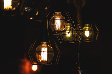 Indoor LED lighting lamps in dark room creating glowing light. Light bulb with low energy filament....