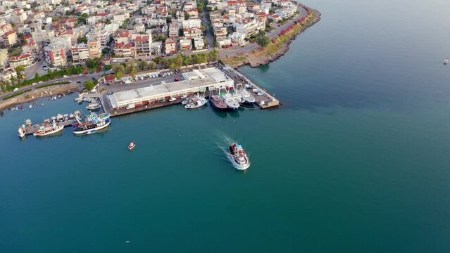 4K aerial - a bird's eye view&nbsp;video (Ultra High Definition) of fishing port. Morning in Chalcis town. Nice morning seascape of Aegean sea, North Euboean Gulf. Summer scene of Euboea island, Greece.