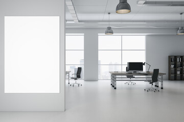 Front view on blank white poster on light grey wall in minimalistic coworking office with city view from windows, light walls and computers on wooden tables and glossy floor. 3D rendering, mock up