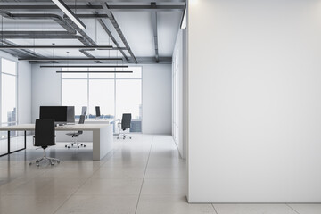 Front view on blank white wall with place for advertising poster in spacious office with monochrome interior design, light floor, loft ceiling lamps and big window background. 3D rendering, mockup