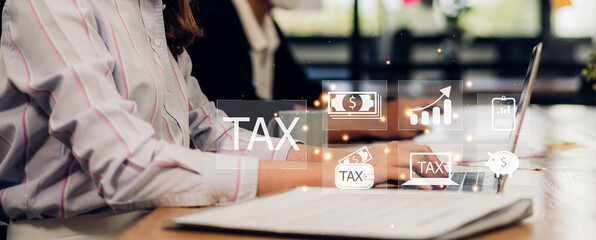 Success Businesswoman use laptop computer with complete income paying taxes receipt online for payment calculation tax return and financial research at home.TAX and VAT Time concept