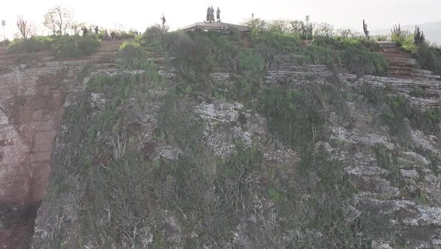 koko head drone aerial reveal of hawaii kai and hikers on top of mountain panning to show hawaii kai and hanauma bay midday lots of sun