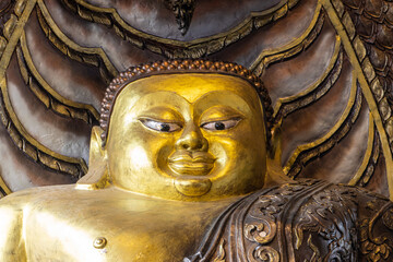 Buddha sitting under the protection of The Naga in a Buddhist temple, Thailand