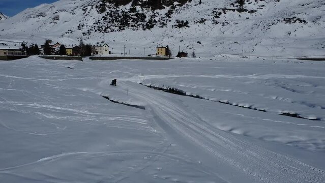 Snowmobiling scene in the italian alps