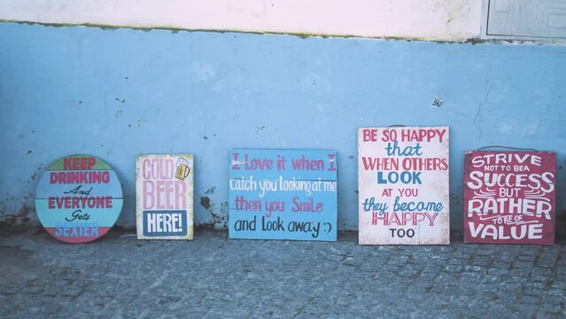 Signs with terms of endearment and motivation rest against the wall
