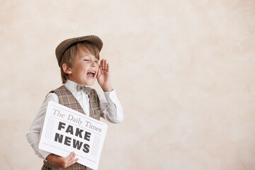 Newsboy shouting against grunge wall background. Boy selling fake news - 558079400