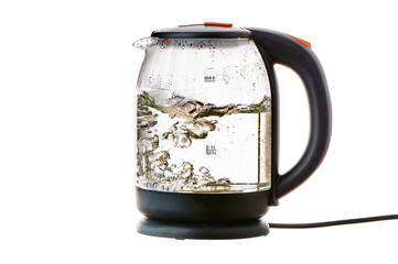 Glass electric kettle with boiling water on a white insulated background